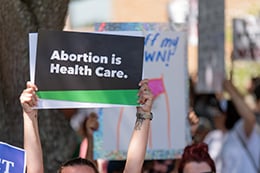 A person holding a sign that says Abortion is Health Care