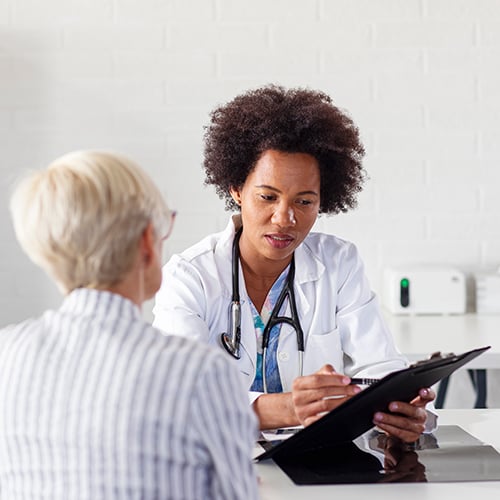 A doctor reading a form to a patient