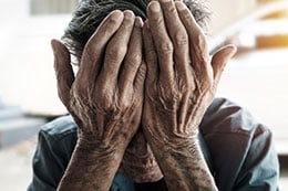 A person with their hands over their face