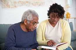 An elderly man reading a book