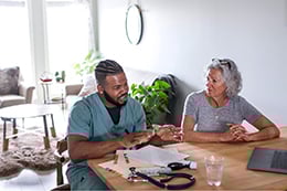 A nurse taking care of a patient at home