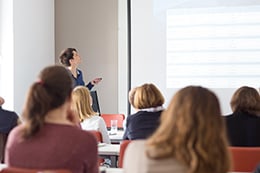 A woman presenting in front of a group