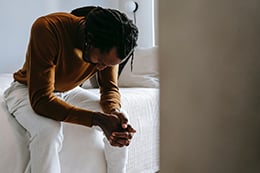 A man sitting on a bed