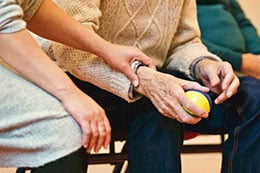 A nurse helping an elderly person